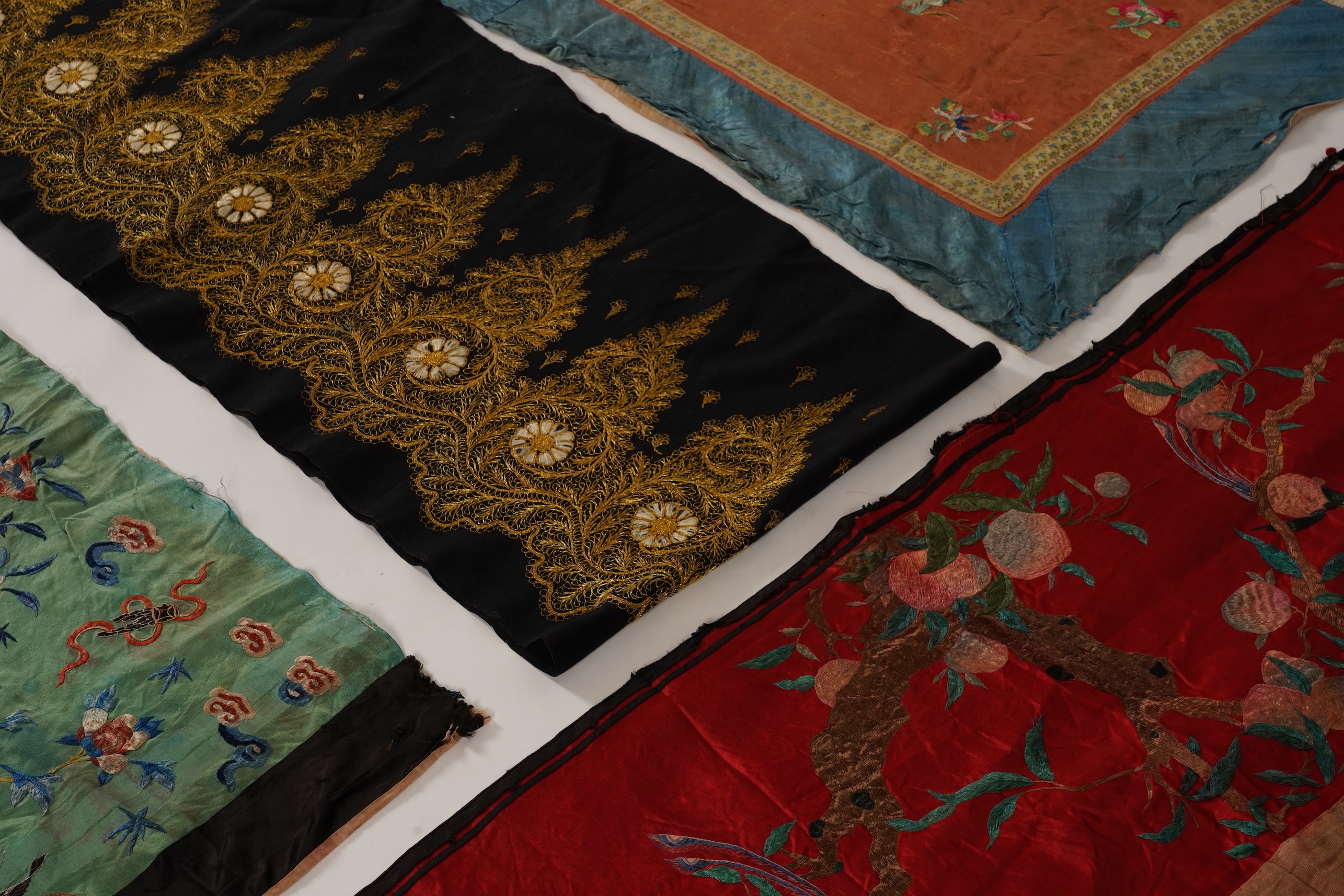 Four Chinese embroidered silk panels, late 19th/early 20th century and a similar Indian panel